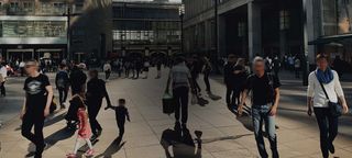 City central square with people casually strolling, with censored faces